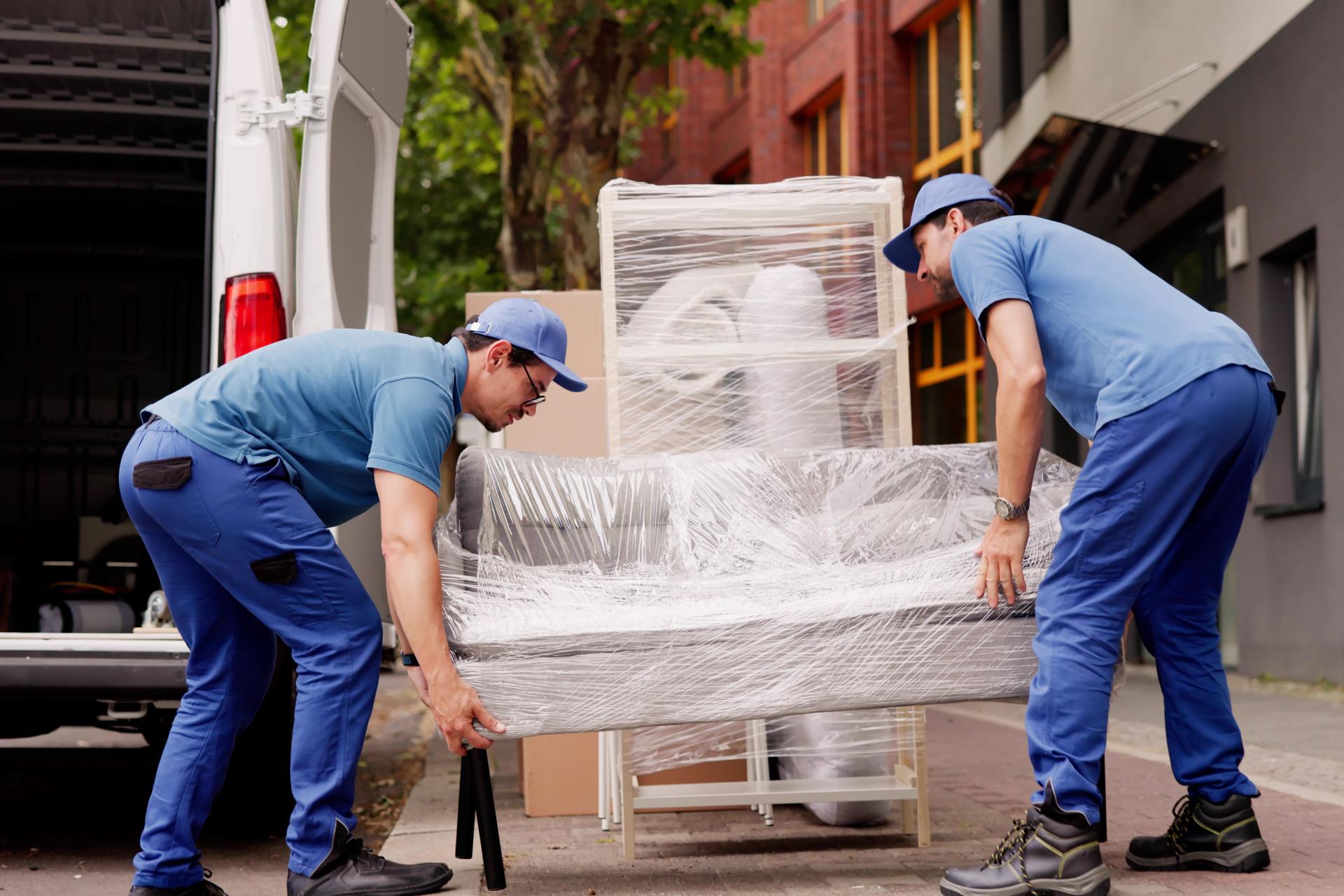 Professional Movers Outside Delivering Furniture Removal Service With Truck
